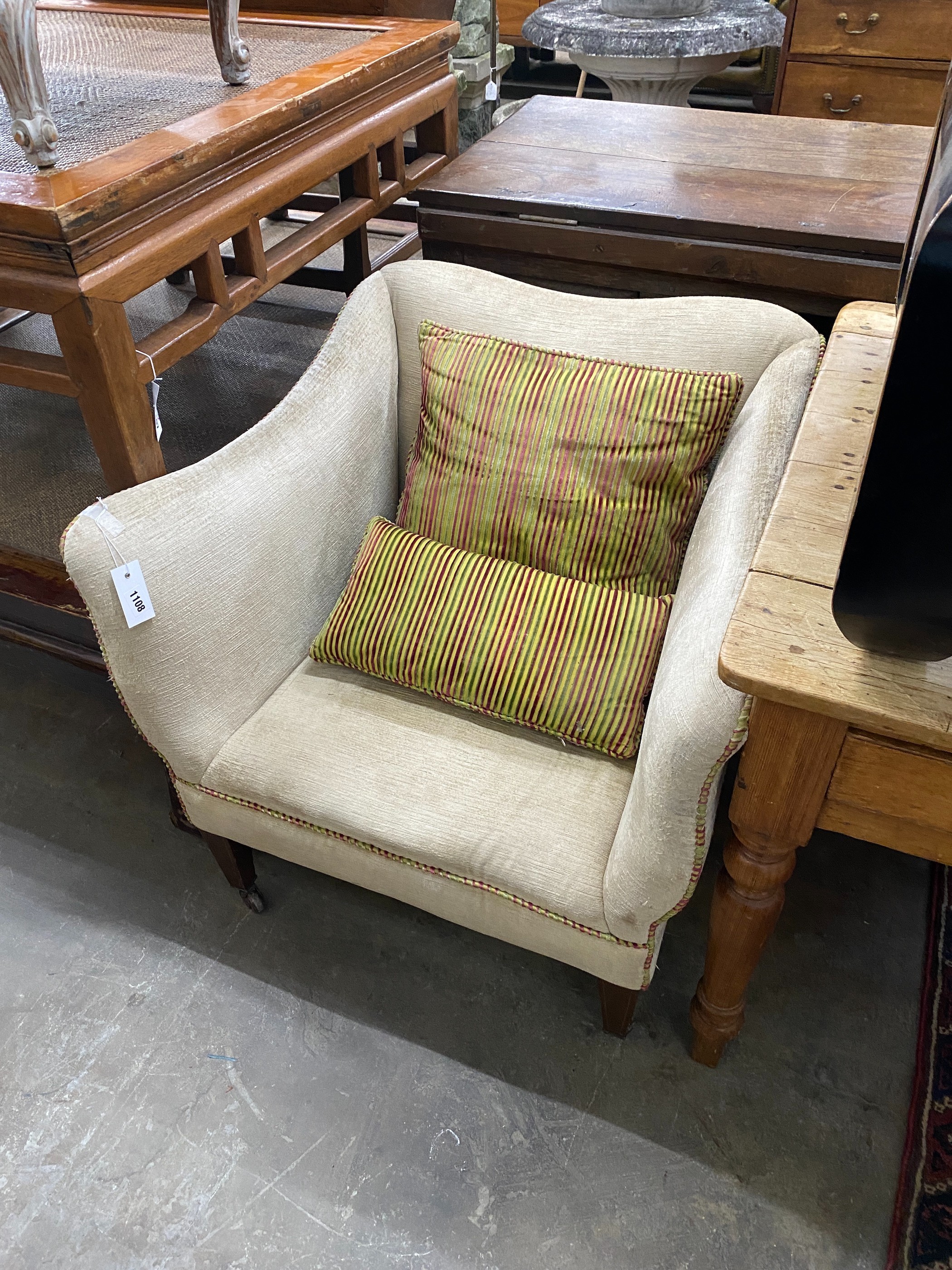 An Edwardian upholstered armchair together with a 19th century style painted footstool